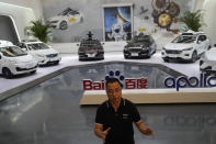 Wei Dong, vice president of Baidu's Intelligent Driving Group, speaks near a display showing the various prototypes of the self-driving taxi developed by tech giant Baidu Inc. on June 14, 2022, in Beijing. Baidu Inc. is China's highest-profile competitor in a multibillion-dollar race with Alphabet Inc.'s Waymo and General Motors Co.'s Cruise to create self-driving cars. (AP Photo/Ng Han Guan)