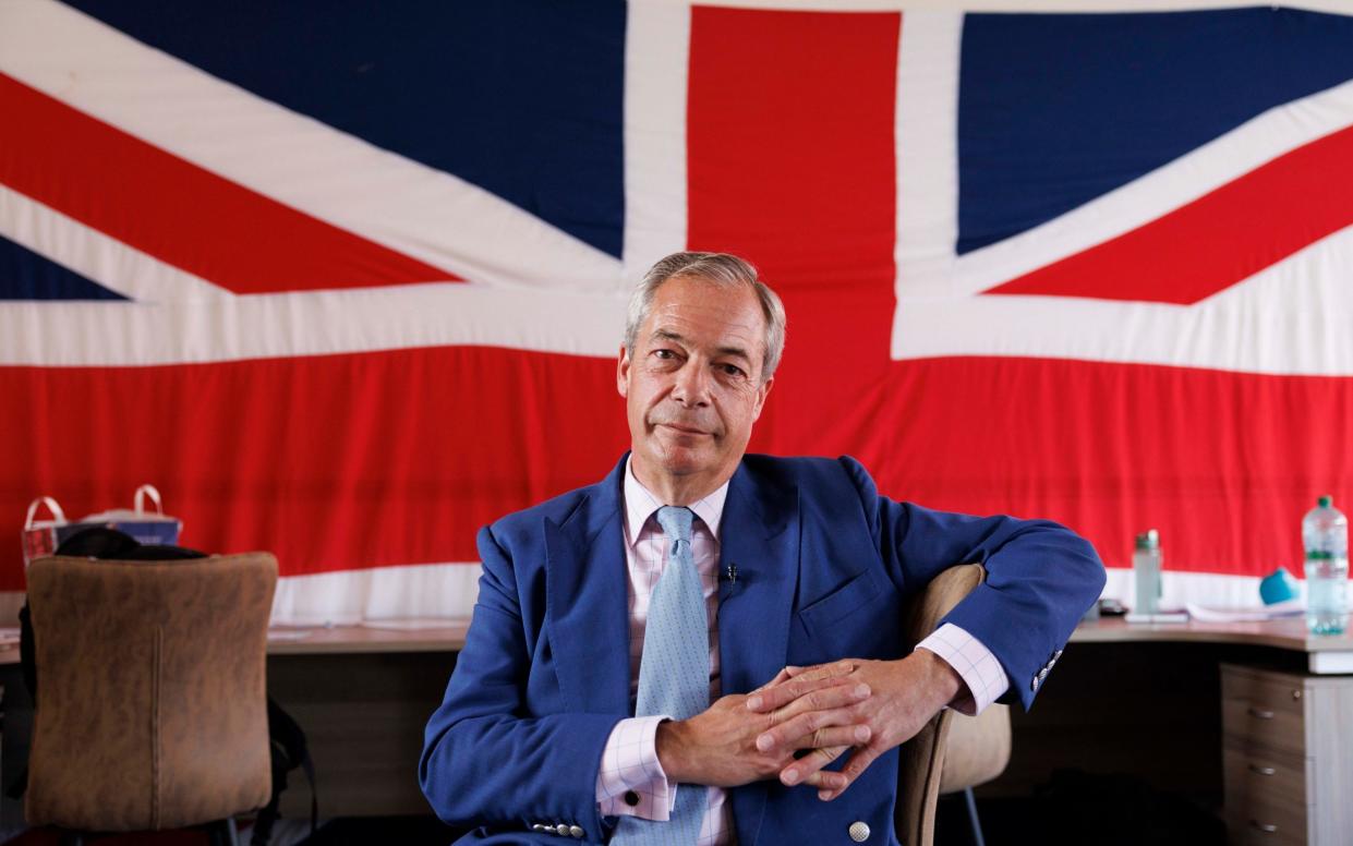 Nigel Farage in Clacton HQ in front of a large scale British flag