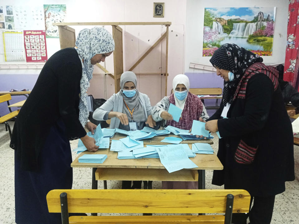 Election officials count votes inside a polling station in the municipality election in Algiers, Algeria, Saturday, Nov. 27, 2021. Algerians are voting Saturday to elect their mayors and regional leaders amid widespread worry and frustration over rising prices for basic goods, housing and health care. (AP Photo/ Moh Ali)