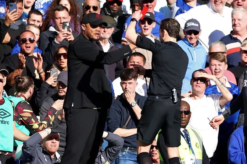 Vincent Kompany is shown a red card by referee Darren England