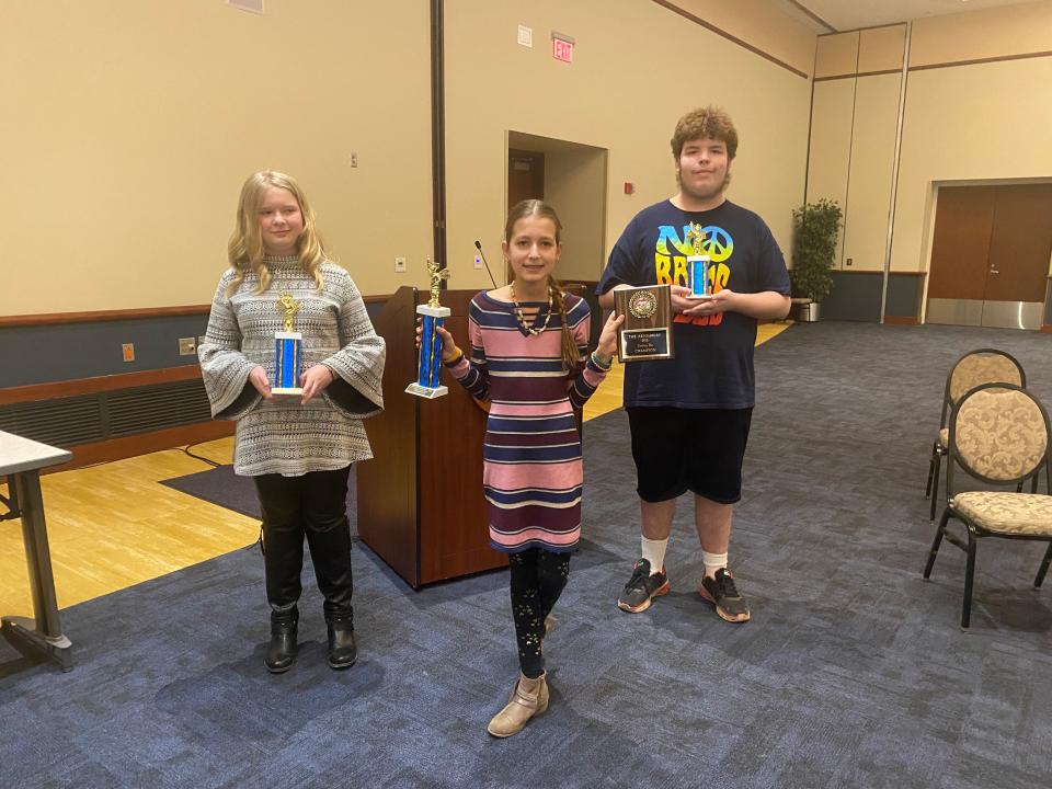 Ava Moneypenny, from left, Julianne Liliestedt and Hunter Sanders pose with their trophies at Kent State Stark's Conference Center after winning the Canton Repository Regional Final Spelling Bee in March. Julianne finished first.