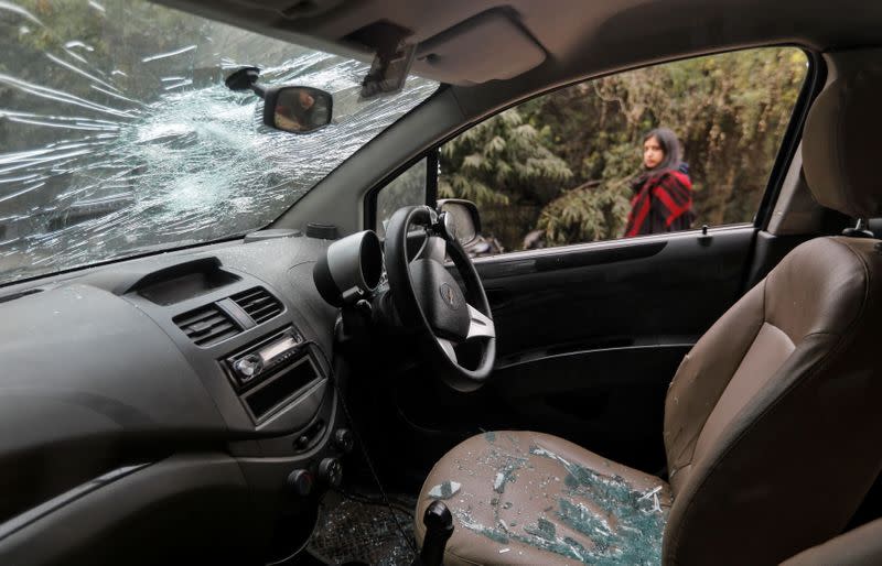 A damaged car is seen parked after the attacks on students of Jawaharlal Nehru University (JNU) on Sunday, on the university campus in New Delhi