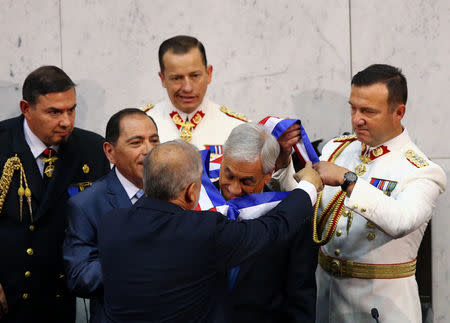Chile's newly sworn in President Sebastian Pinera receives the sash from President of the Senate Carlos Montes at the Congress in Valparaiso, Chile March 11, 2018. REUTERS/ Ivan Alvarado