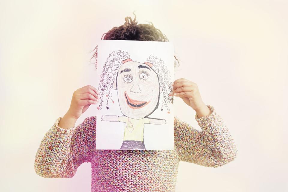 portrait of young girl, holding drawing, covering face fun activities for kids