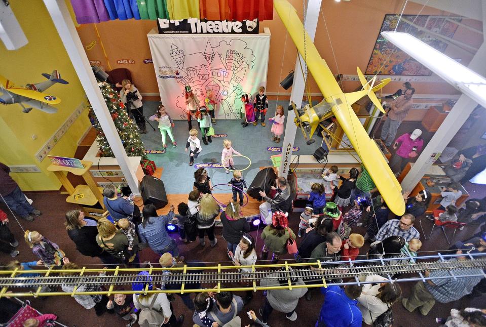 Children dance on stage while waiting for balloons to drop during the 2016 Noon Year's Eve celebration at the Experience Children's Museum. [FILE PHOTO/ERIE TIMES-NEWS]