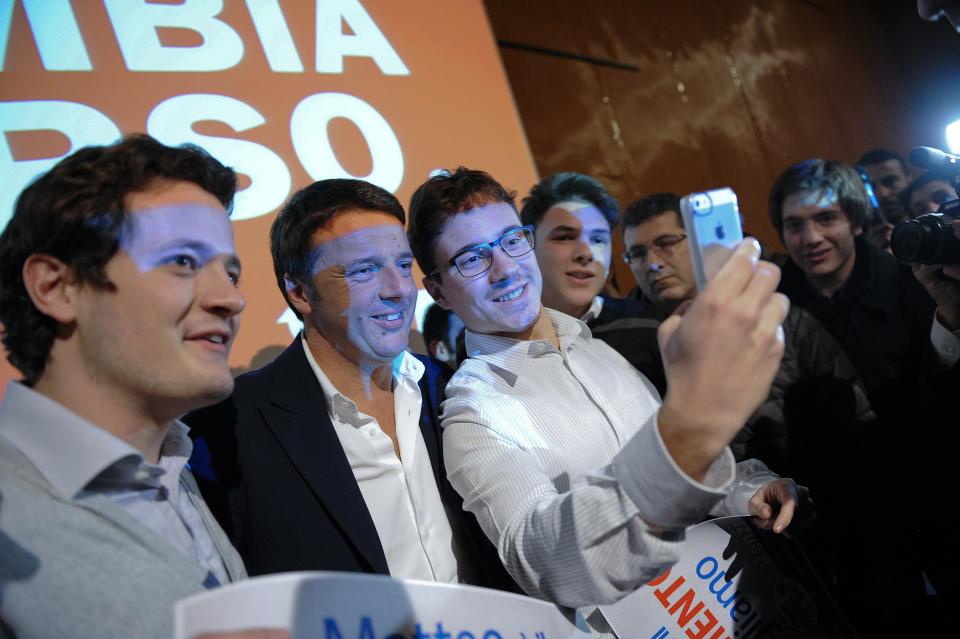 Florence mayor Renzi poses with young supporters during a political meeting in Turin