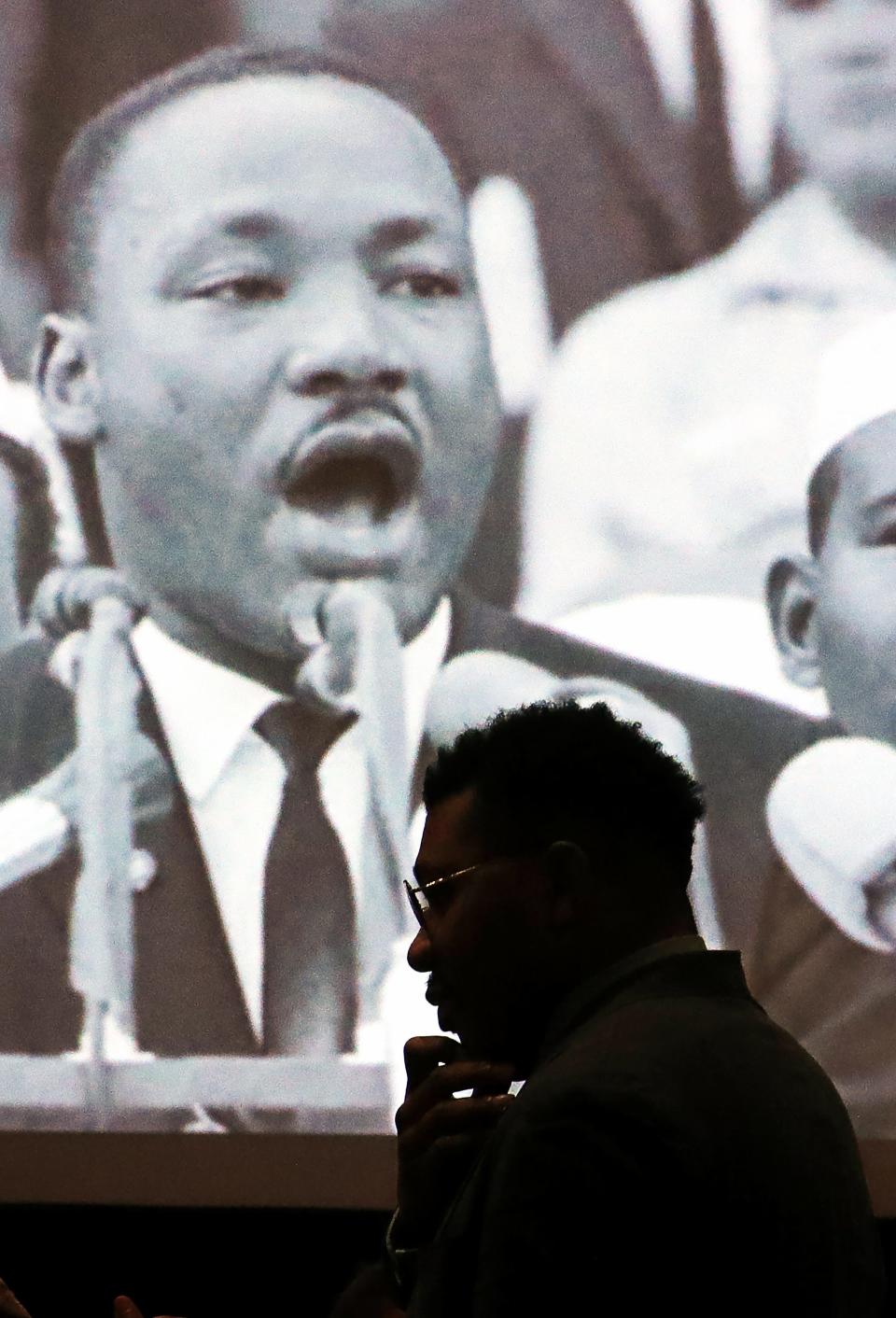 A photograph of Martin Luther King Jr. appears to watch over members of the Akron Urban League as they gather for their Martin Luther King Jr. Day Breakfast Monday in Fairlawn.