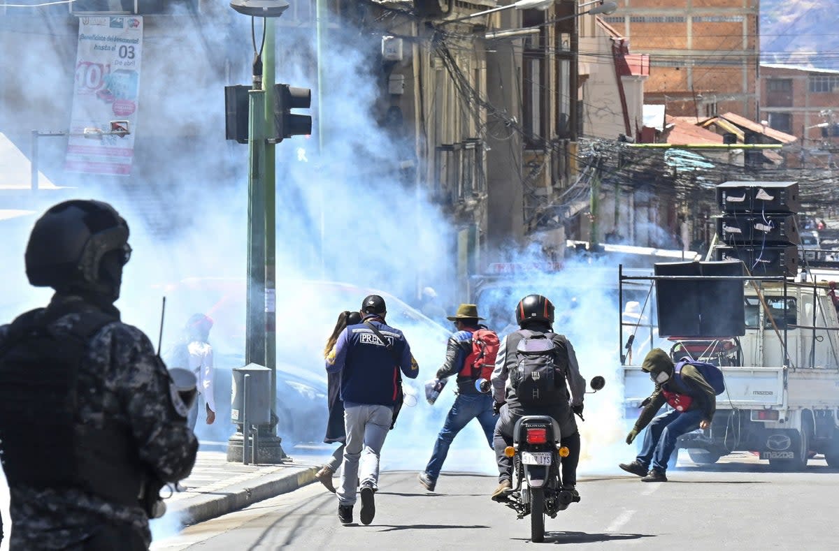 Riot police fire rubber bullets and tear gas at education workers during a protest demanding a bigger budget for the sector and rejecting a new education plan from Bolivian President Luis Arce’s government on 22 March (AFP via Getty Images)