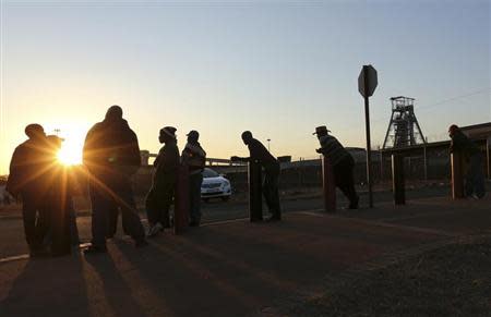 Mine workers await their shift outside the Doornkop Gold Mine, about 30 km (19 miles) west of Johannesburg September 3, 2013. REUTERS/Siphiwe Sibeko