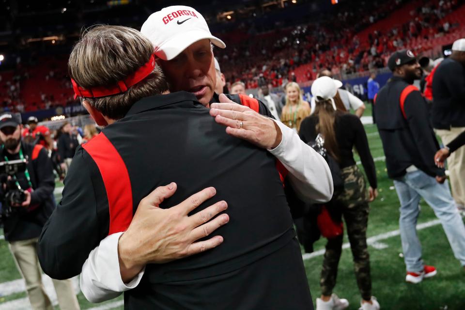 Georgia head coach Kirby Smart hugs Georgia Offensive Coordinator Todd Monken after winning the SEC Championship NCAA college football game between LSU and Georgia in Atlanta, on Saturday, Dec. 3, 2022. Georgia won 50-30.