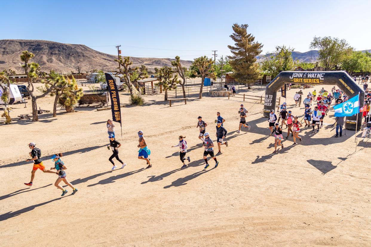 Runners take off in the John Wayne Grit Series in Pioneertown in 2021. Proceeds from the races go towards funding the John Wayne Cancer Foundation.