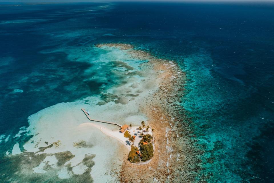 A breathtaking bird's eye view of a small island in Belize surrounded by Caribbean Sea