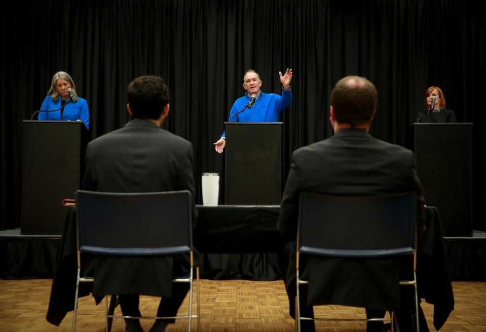 Democratic candidates for Polk County attorney (from left) Kimberly Graham, Kevin McCarthy, and Laura Roan participate in the Polk County attorney candidate forum at the Olmsted Center at Drake University in Des Moines on Tuesday, May 24, 2022.