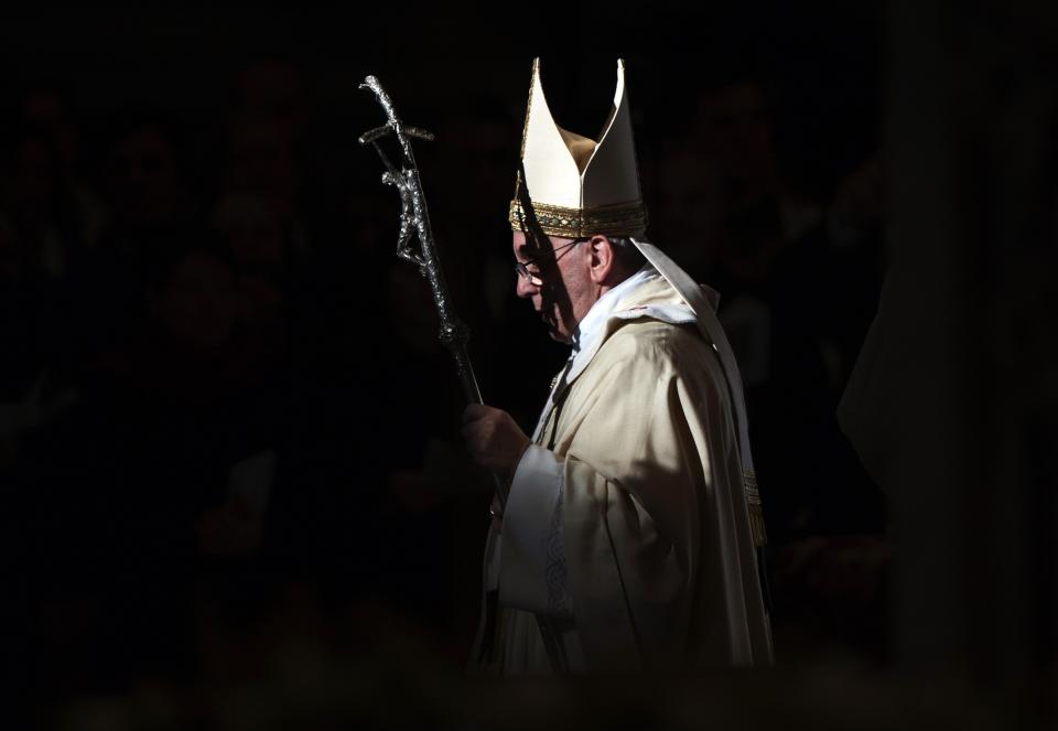 Pope Francis walks with his pastoral staff as he leads the Epiphany mass in Saint Peter's Basilica at the Vatican