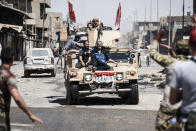 <p>Iraqis fleeing the Old City of Mosul arrive to the industrial district of the city on June 23, 2017 as they flee the fighting between Iraqi forces and Islamic State (IS) group jihadists. A suicide bomber blew himself up among civilians fleeing Mosul’s Old City, where Iraqi forces are gaining ground against jihadists mounting a fierce but desperate defence, officers said. (Photo: Mohamed el-Shahed/AFP/Getty Images) </p>