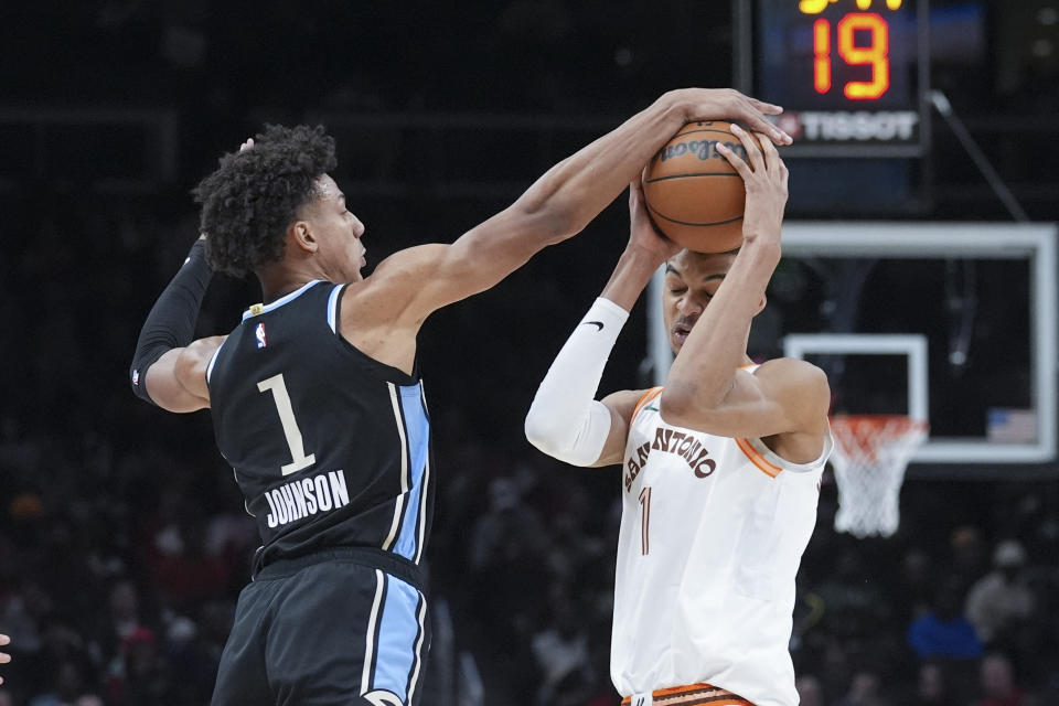 Atlanta Hawks forward Jalen Johnson (1) blocks San Antonio Spurs center Victor Wembanyama's (1) shot during the first half of an NBA basketball game Monday, Jan. 15, 2024, in Atlanta. (AP Photo/John Bazemore)