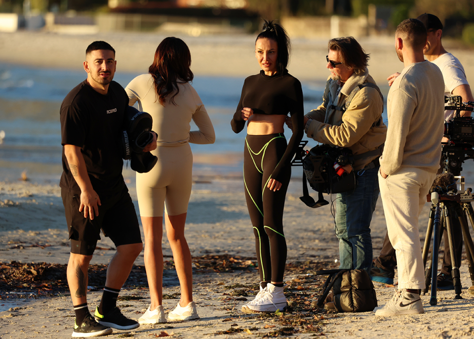 Krissy Marsh and Jono Castano filming The Real Housewives of Sydney on the beach.