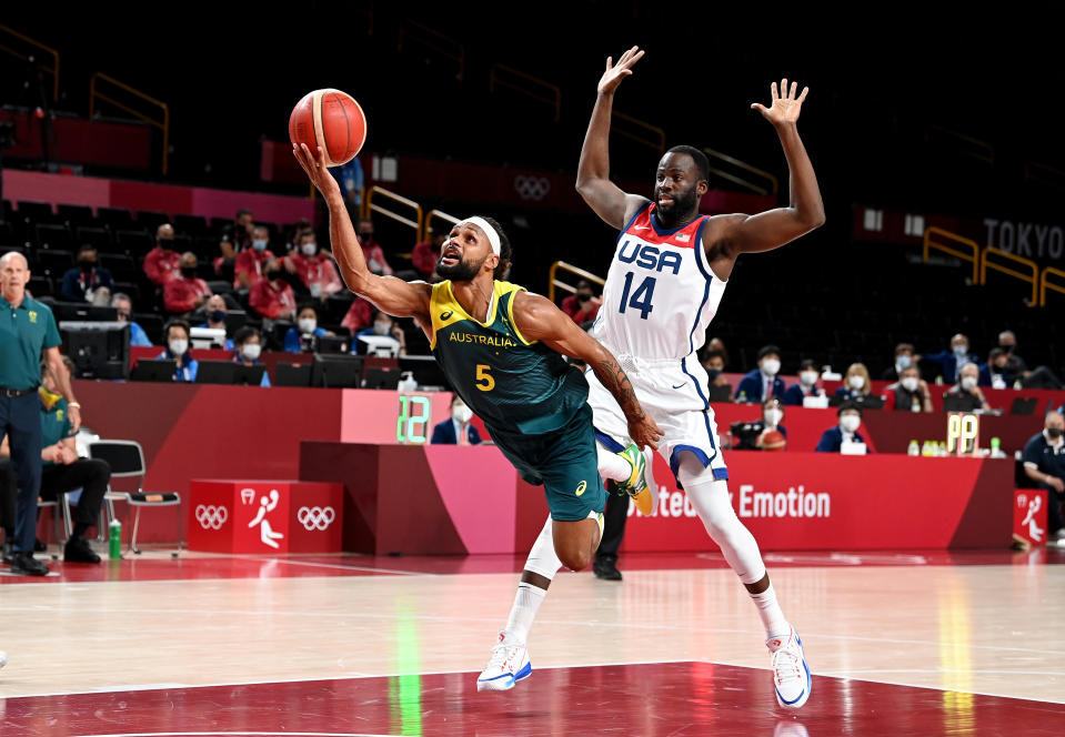 <p>Patty Mills of Australia is fouled by Draymond Green of the USA during the Basketball semi final match between Australia and the USA on day thirteen of the Tokyo 2020 Olympic Games at Saitama Super Arena on August 05, 2021 in Saitama, Japan. (Photo by Bradley Kanaris/Getty Images)</p> 