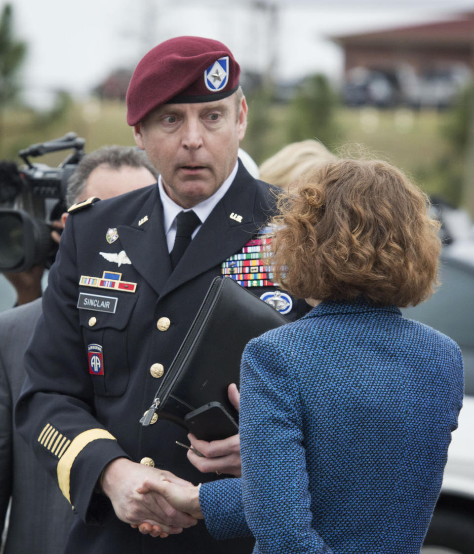 Brig. Gen. Jeffrey Sinclair shakes hands with his defense attorney Ellen C. Brotman outside the Fort Bragg, N.C., courthouse, Monday, March 17, 2014. Sinclair, who admitted to improper relationships with three subordinates, appeared to choke up as he told a judge that he'd failed the female captain who had leveled the most serious accusations against him. (AP Photo/The Fayetteville Observer, Johnny Horne)