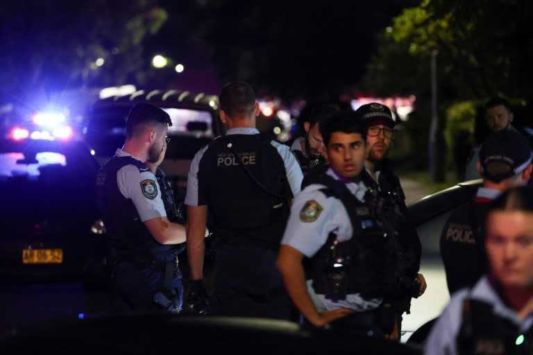 Police gather outside the Christ the Good Shepherd Church in Sydney's western suburb of Wakeley on Monday night (David GRAY)