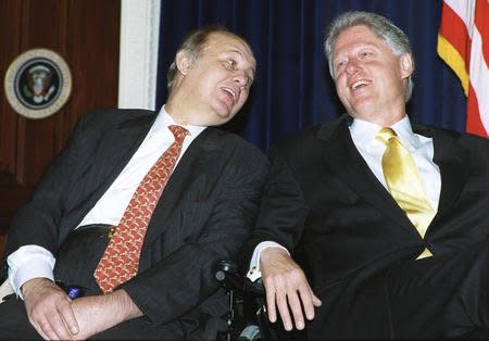 President Bill Clinton (R) and Jim Brady (C) share a moment during the 7th anniversary of the signing of the Brady Law on gun control in the Eisenhower Executive Office Building in Washington, November 30, 2000. File Photo by Ricardo WatsonUPI
