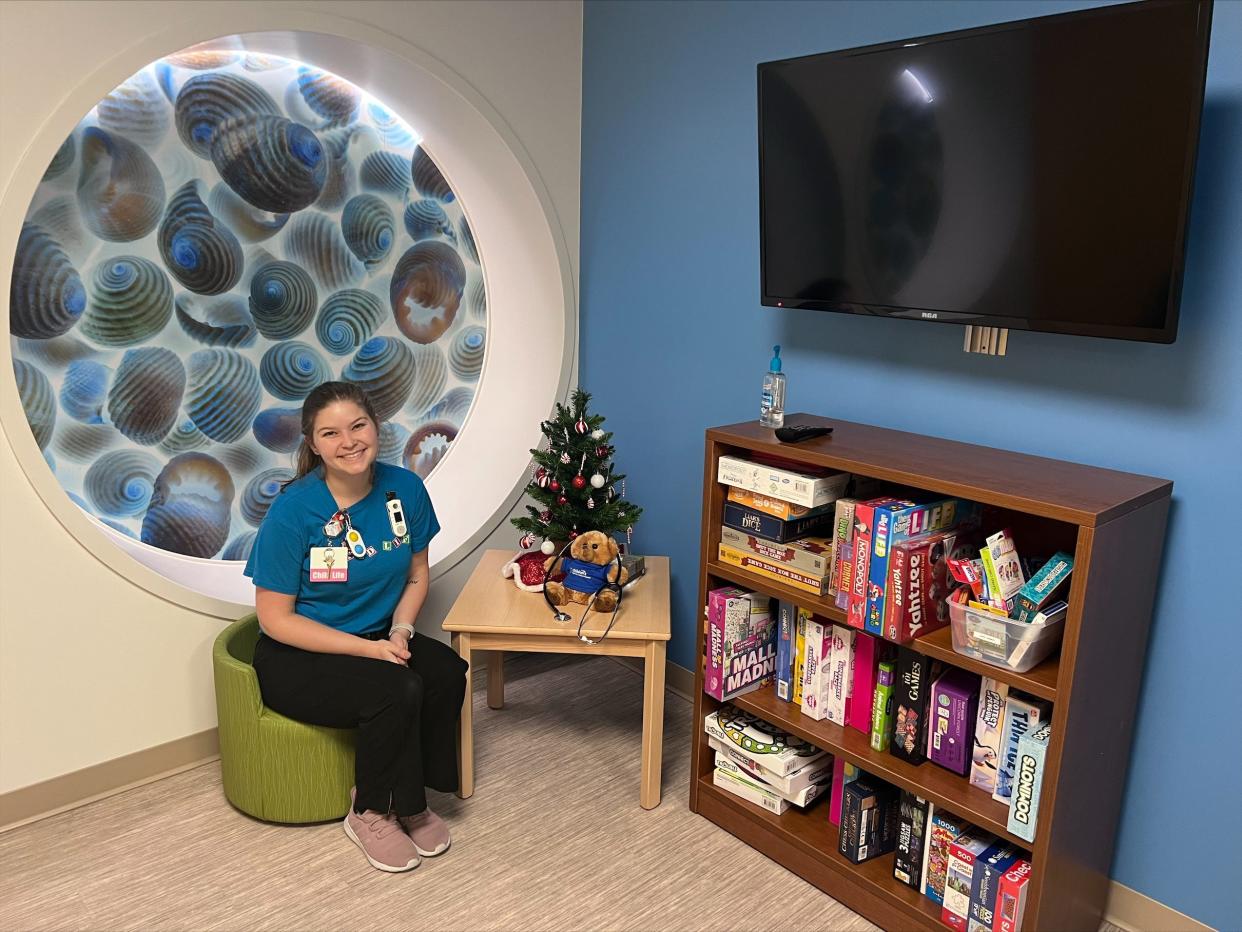 Caitlin Kapp, a certified child life specialist at HSHS St. Vincent Children's Hospital, sits in the hospital's teen lounge, where Youth Cancer Support Group sessions take place.