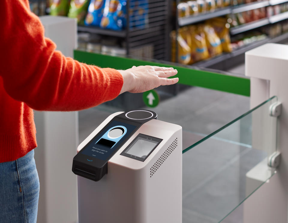 This undated photo provided by Amazon shows the Amazon One device at an Amazon Go store in Seattle. Amazon has introduced the new palm recognition technology in a pair of Seattle stores and sees broader uses in places like stadiums and offices. Customers at the stores near Amazon's campus in Washington can flash a palm for entry and to buy goods. (Amazon via AP)