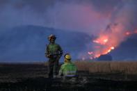 FILE PHOTO: Firefighters work at the site of a wildfire outside Tabara, Zamora, on the second heatwave of the year