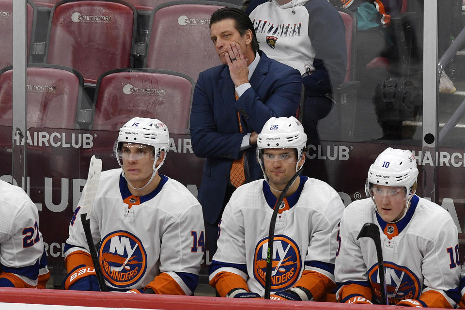 FILE - New York Islanders coach Lane Lambert watches from behind the bench during the first period of an NHL hockey game against the Florida Panthers, Saturday, Dec. 2, 2023, in Sunrise, Fla. The New York Islanders fired Lambert and replaced him with Hall of Fame goaltender Patrick Roy, President of hockey operations and general manager Lou Lamoriello announced Saturday, Jan. 20, 2024. (AP Photo/Michael Laughlin)