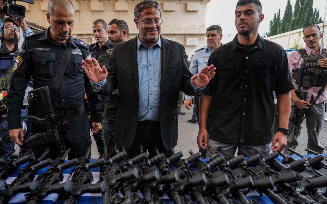 Itamar Ben-Gvir, Israel's national security minister, pictured with rifles being handed out to volunteer groups