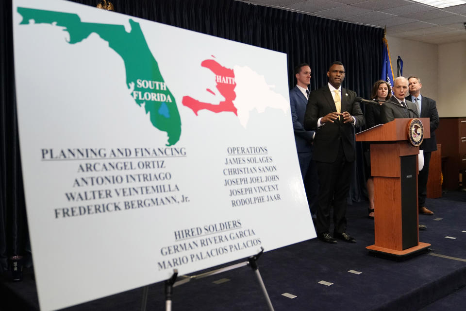 Markenzy Lapointe, U.S. Attorney for the Southern District of Florida, left, speaks as Matthew Olsen, Assistant Attorney General for National Security, second from right, looks on during a news conference, Tuesday, Feb. 14, 2023, in Miami. U.S. authorities have arrested four more people in the slaying of Haitian President Jovenel Moïse, including the owner of a Miami-area security company that hired former soldiers from Colombia for the mission. (AP Photo/Lynne Sladky)