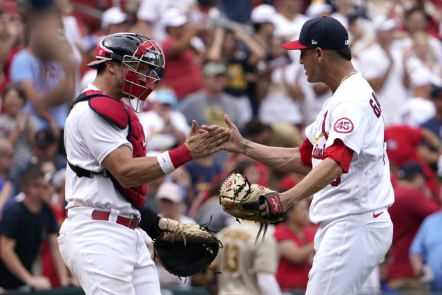 St. Louis Cardinals relief pitcher Giovanny Gallegos and catcher Andrew Knizner celebrate an 8-7 victory over the San Diego Padres in a baseball game Sunday, Sept. 19, 2021, in St. Louis. (AP Photo/Jeff Roberson)