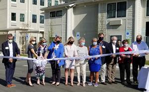 SECU Foundation Executive Director Jama Campbell (third from left) assists in Ribbon Cutting with Family House supporters and leaders, including SECU Family House Executive Director Janice McAdams (center).