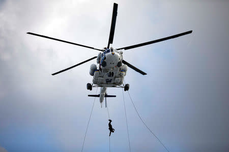 A member of Special Weapon and Tactics (SWAT) rappels down during an anti-terror drill as a part of the Ulchi Freedom Guardian exercise in Goyang, South Korea August 21, 2017. REUTERS/Kim Hong-Ji