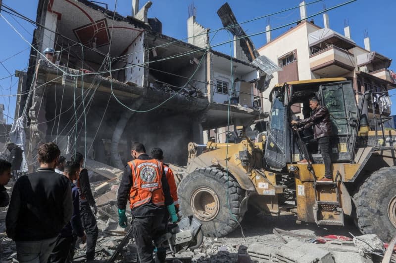 A tractor removes the rubble of a ruined house following an Israeli air strike. Abed Rahim Khatib/dpa