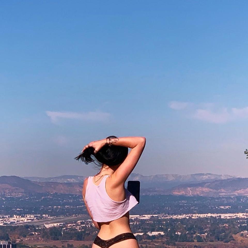 Noah Cyrus faces hills in lingerie and a tank top