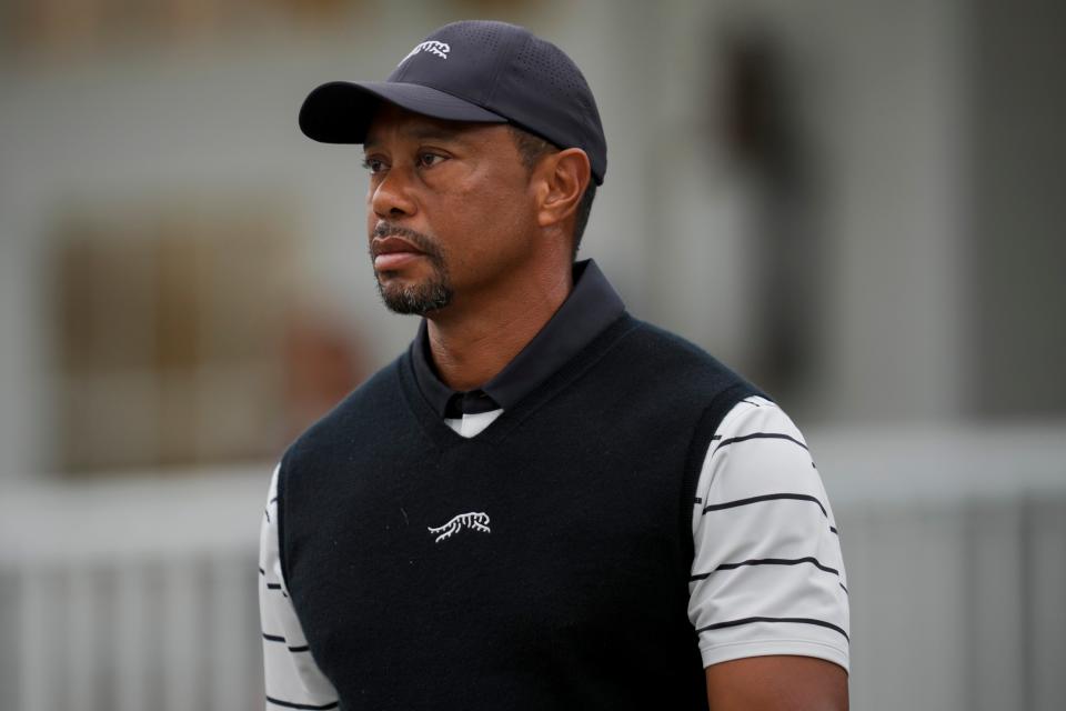 Tiger Woods walks off the course as play is suspended due to inclement weather during a practice round for the PGA Championship golf tournament at Valhalla Golf Club.