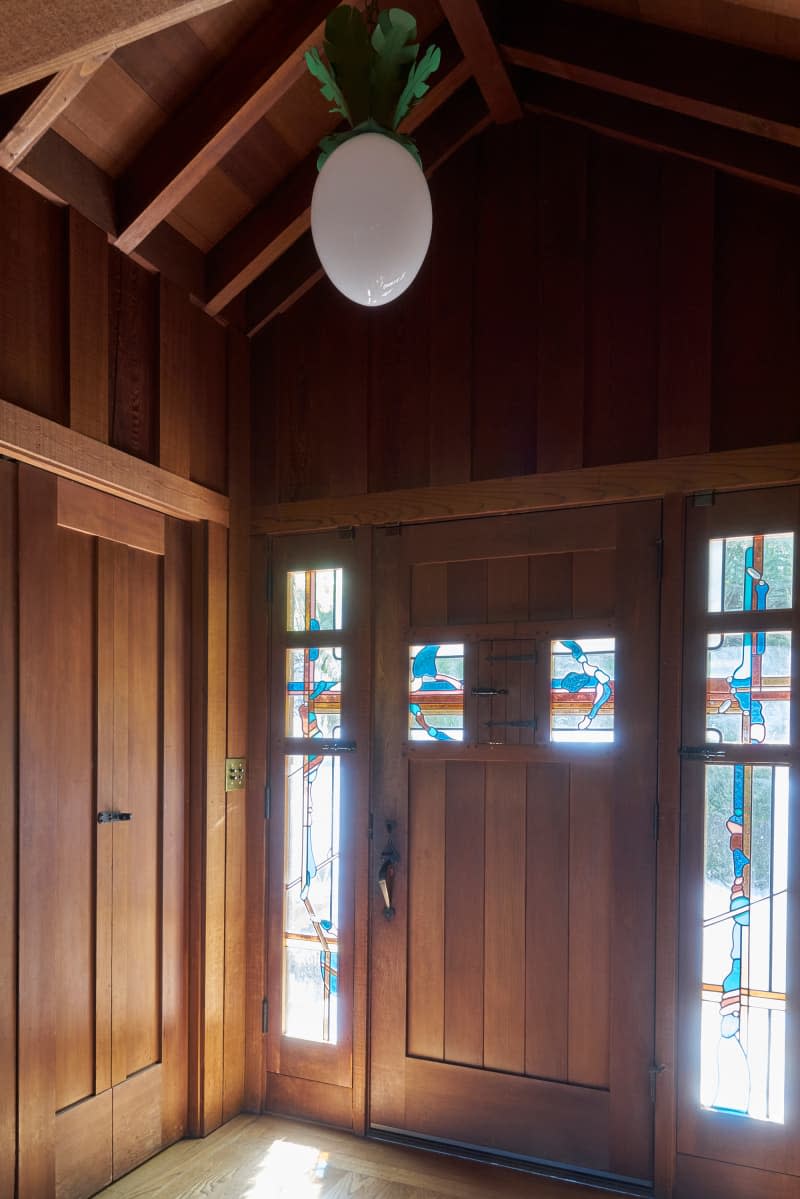 Wood paneled wall in entry way of hunting lodge.