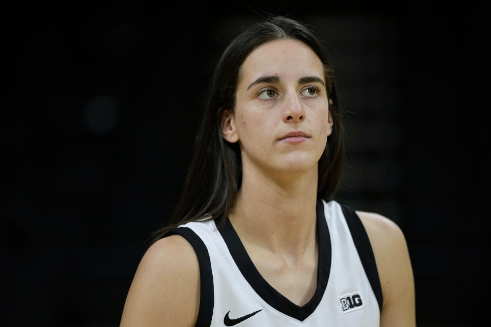 Iowa guard Caitlin Clark stands on the court during Iowa's NCAA college basketball media day Oct. 4, 2023, in Iowa City, Iowa. Clark is embracing her role as an ambassador for the game after she led Iowa to the NCAA championship game last season. She enters this season with 90 straight double-figure scoring games and a 27.3-point career average. (AP Photo/Charlie Neibergall)