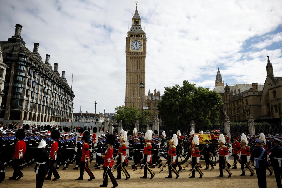 The coffin of Queen Elizabeth II is pulled past Parliament Square following her funeral service in Westminster Abbey in central London, Monday, Sept. 19, 2022. The Queen, who died aged 96 on Sept. 8, will be buried at Windsor alongside her late husband, Prince Philip, who died last year. (Sarah Meyssonnier/Pool Photo via AP)