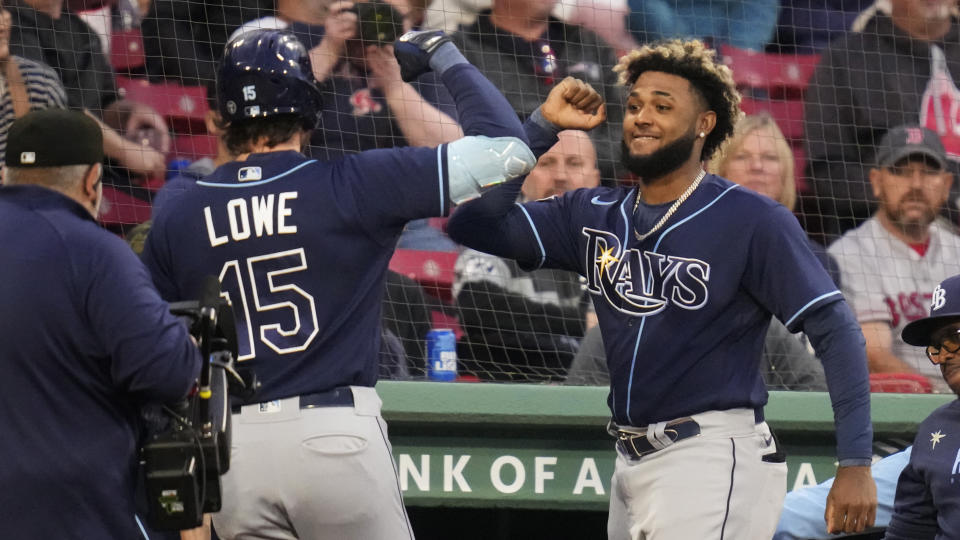 Tampa Bay Rays' Josh Lowe (15) is congratulated by Junior Caminero, right, after his solo home run during the second inning of a baseball game against the Boston Red Sox at Fenway Park, Wednesday, Sept. 27, 2023, in Boston. (AP Photo/Charles Krupa)