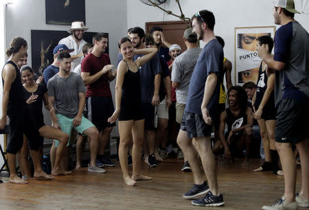 A dancer with Cuba's National Ballet School (C) jokes with players from Rice University's baseball team, which had to cancel four of their five exhibition games against Cuban professional teams when Fidel Castro died during their visit here, in Havana, Cuba, December 1, 2016. REUTERS/Stringer