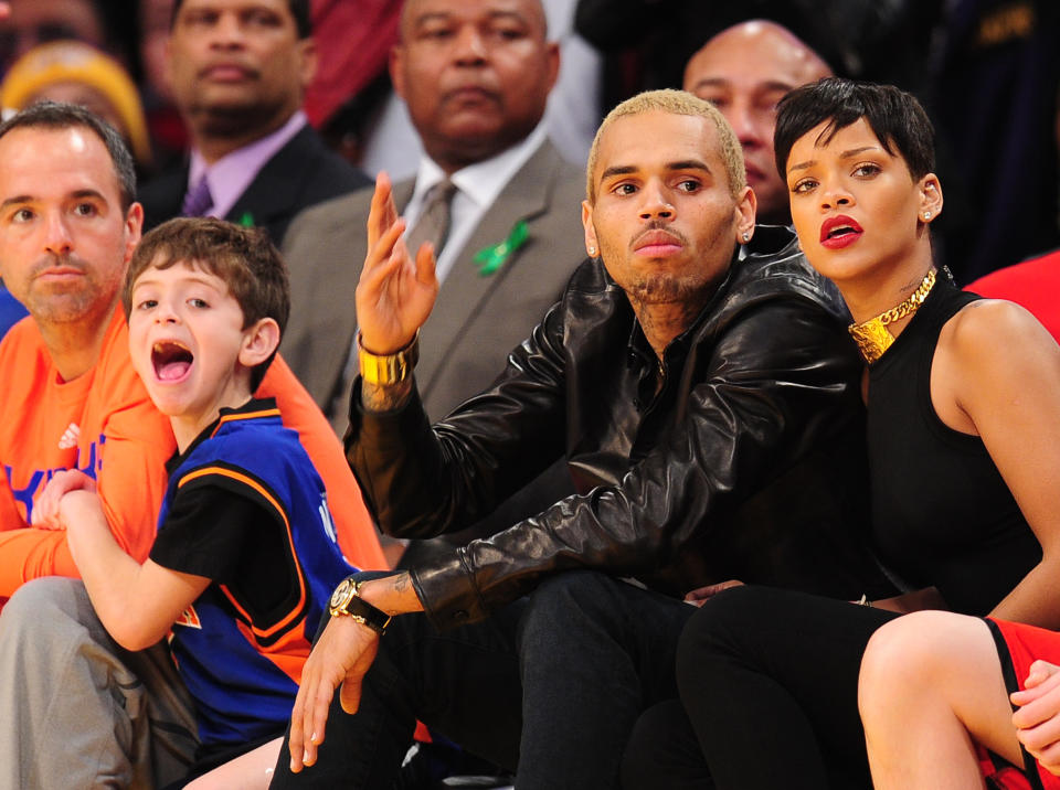 Rihanna and Chris Brown watch the action during an NBA game between the New York Knicks and the Los Angeles Lakers at Staples Center in Los Angeles, California, on Christmas Day, December 25, 2012. 