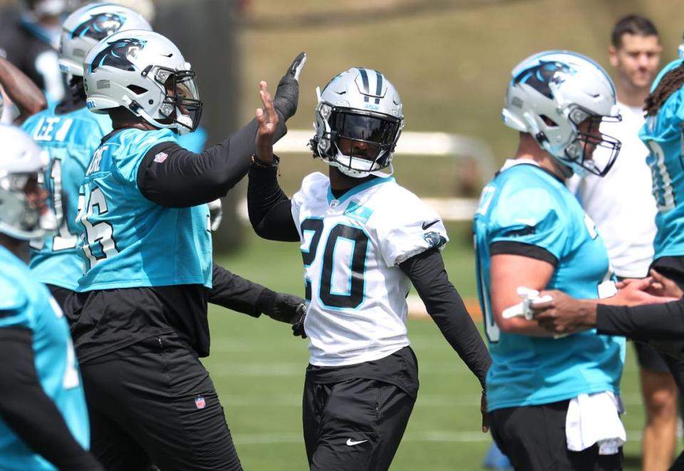 Carolina Panthers safety Jordan Fuller, center, slaps hands with his teammates as they prepare to begin drills during a voluntary minicamp practice on Wednesday, April 24, 2024.