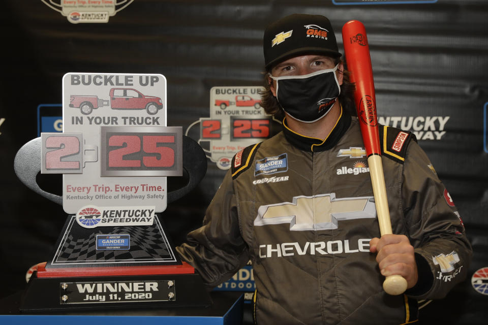 Sheldon Creed poses with the trophy after winning a weather shortened NASCAR Truck Series race Saturday, July 11, 2020, in Sparta, Ky. (AP Photo/Mark Humphrey)