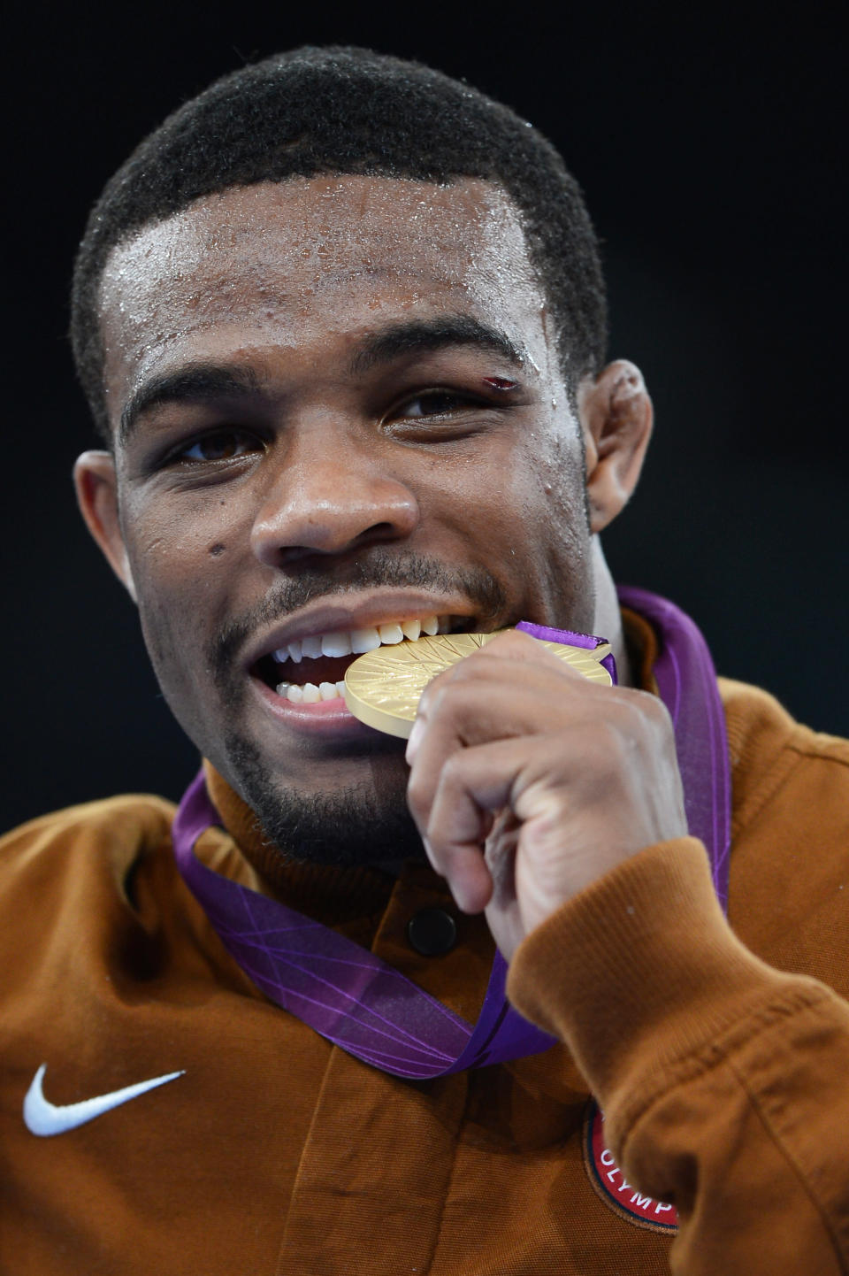 Jordan Ernest Burroughs of the United States celebrates his gold medal in the Men's Freestyle 74 kg Wrestling on Day 14 of the London 2012 Olympic Games at ExCeL on August 10, 2012 in London, England. (Photo by Michael Regan/Getty Images)