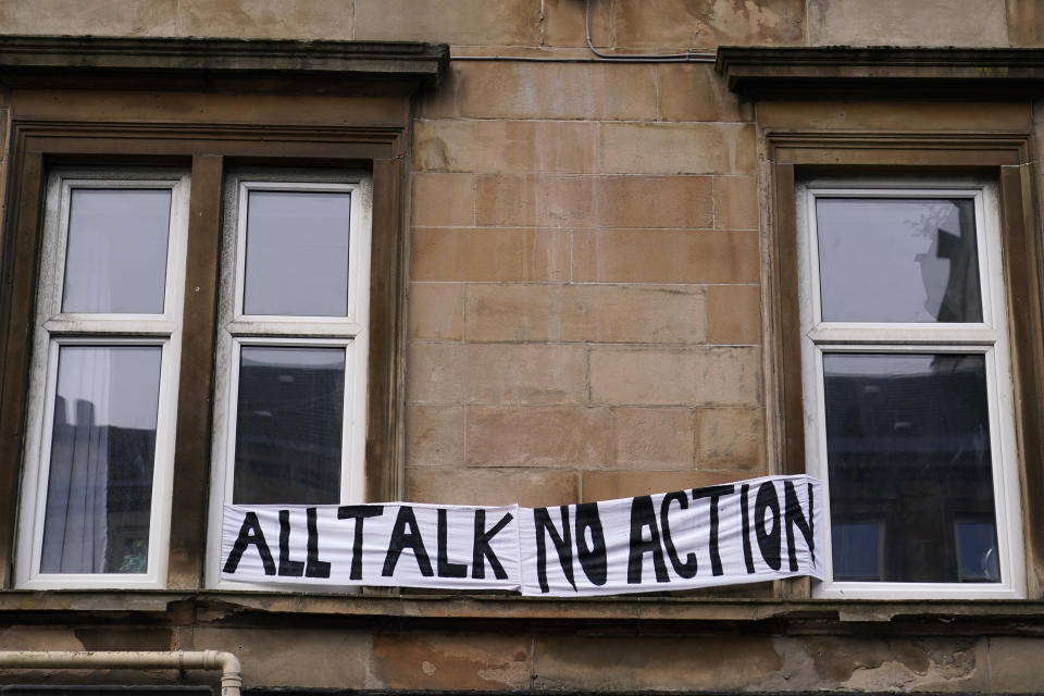 A banner is seen on a building in Glasgow, Scotland, Friday, Nov. 5, 2021 which is the host city of the COP26 U.N. Climate Summit. A protest took place as leaders and activists from around the world were gathering in Scotland's biggest city for the U.N. climate summit, to lay out their vision for addressing the common challenge of global warming. (AP Photo/Alberto Pezzali)