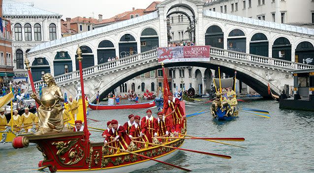 Historical Venetian boats sail past the Rialto bridge along the Grand Canal in 2011. Source: AAP