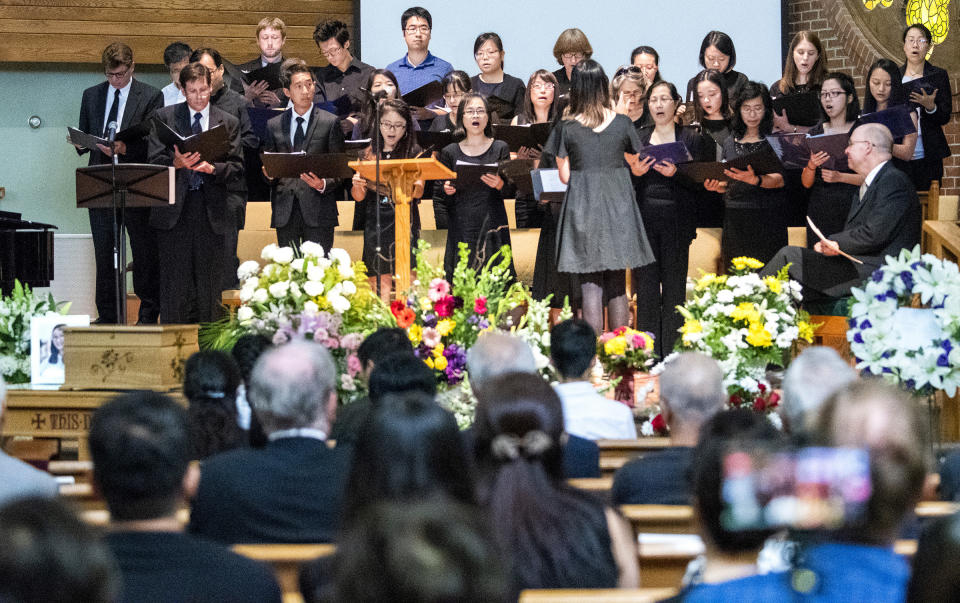 A choir sings during a memorial service for Yingying Zhang, Friday, Aug. 9, 2019 at the First Baptist Church in Savoy, Ill. The family of Yingying Zhang, a Chinese scholar whose body was never recovered after her 2017 slaying gathered at a memorial service that included only her photograph and their own memories of her life. (Robin Scholz/The News-Gazette via AP)