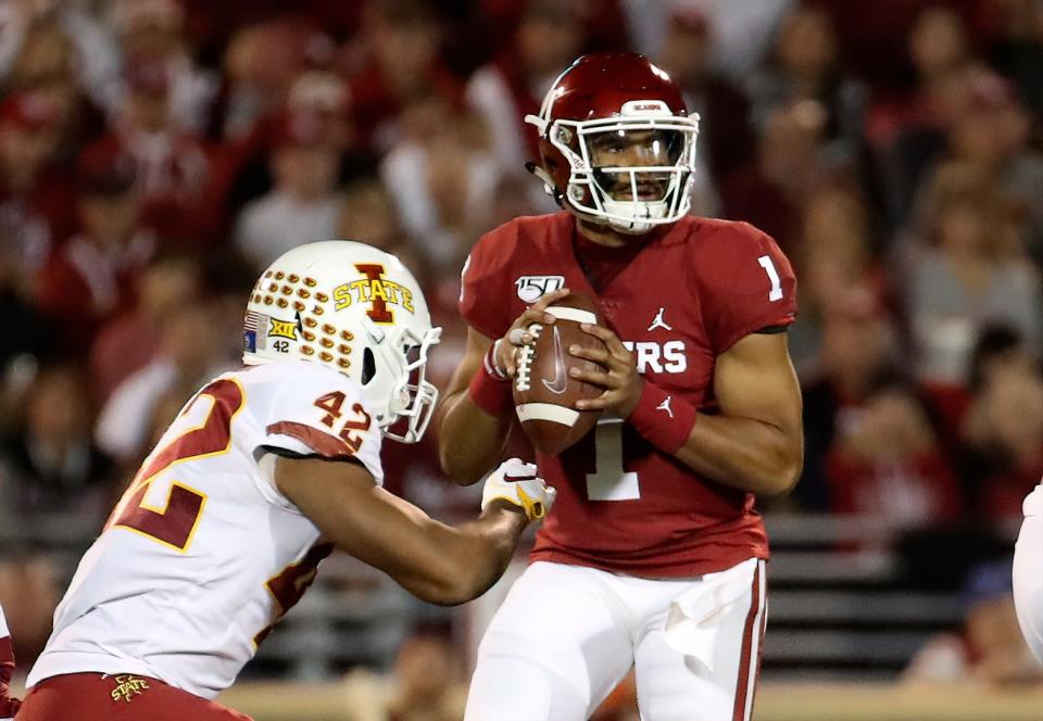 Quarterback Jalen Hurts (1) led the Oklahoma Sooners over linebacker Marcel Spears Jr. (42) and the Iowa State Cyclones during an epic game on Nov. 9, 2019.